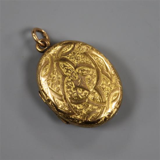 A late Victorian engraved yellow metal pendant locket, 27mm.